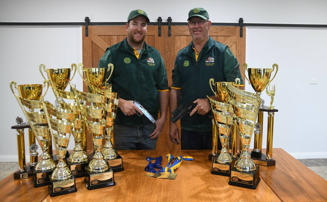 Peter and Dean Brus show off their trophy haul from the pistol World Championships. Picture by Carla Freedman
