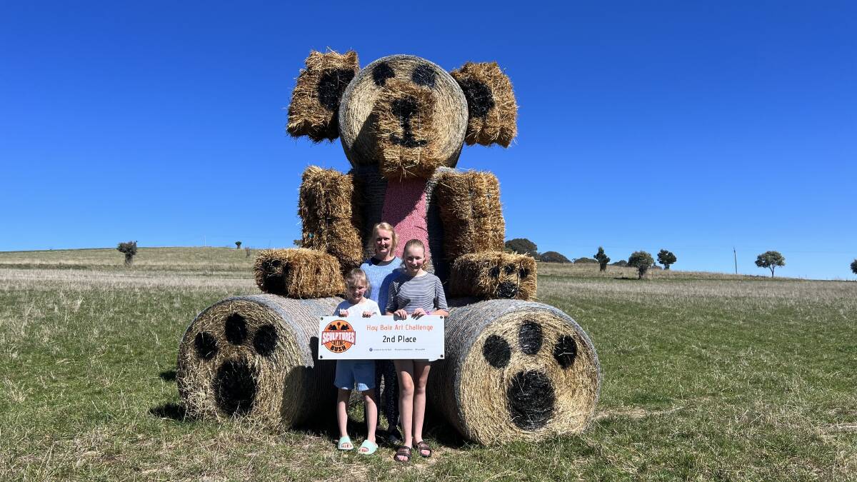 Lila Bonanno, Gemma Bonanno and Lucy Bonanno with their hay bale bear. Picture by Grace Dudley.

