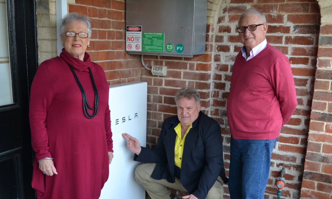 MONEY SAVER: Monica Morse, Rural Green Energy director Darryl Leahey and Michael Morse, with the couple's newly installed Tesla Powerwall. Photo: BRADLEY JURD