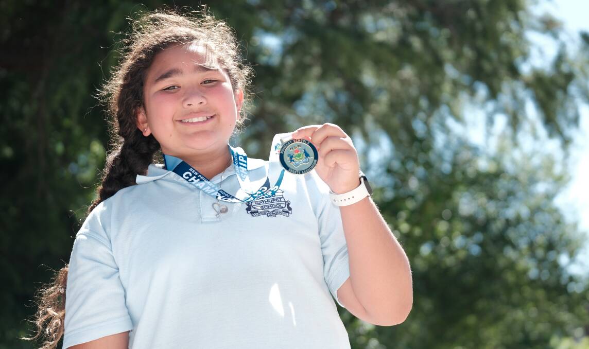 Savannah Auvaa with her gold medal she won for shot put at the NSW PSSA Primary Athletics Championships last month. Picture by James Arrow