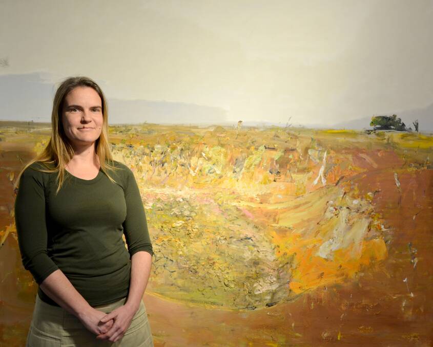 FRESH EYES: Cecilie Knowles is the guest curator for the latest installment of Different Takes. Ms Knowles is pictured in front of John R Walker’s ‘Dry Dam, Bedervale’. 