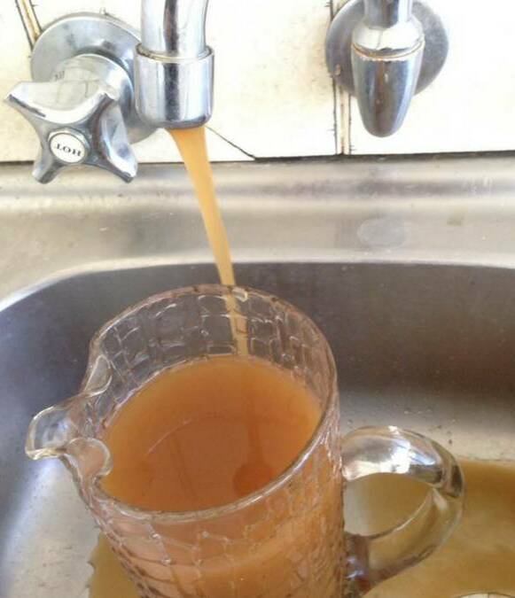 BROWNED OFF: A Facebook image of the water pouring from taps in Gulgong.
