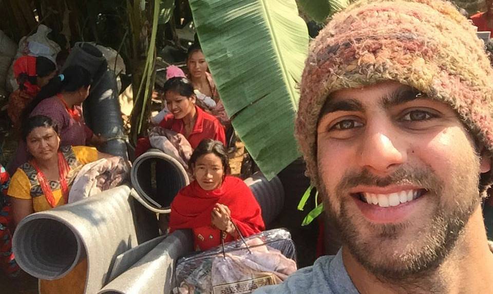 WARM RECEPTION: Nick Abraham with delighted Nepalese villagers who were given bedding and blankets largely donated by his own family. Photo: FACEBOOK