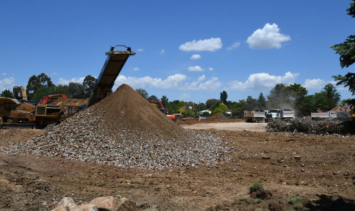 DRAMATIC CHANGE: Rock crushing equipment will be hard at work at the former base hospital site until Christmas. Photo: JUDE KEOGH 1213jkoldhosp2
