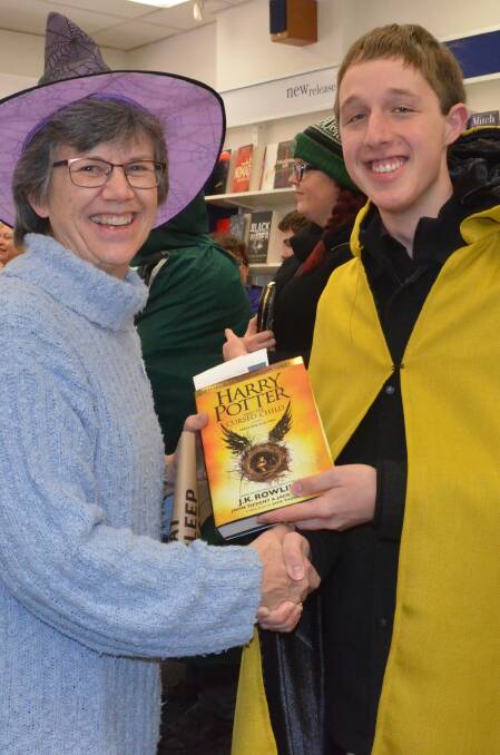 POTTERING ABOUT: Collins Booksellers Orange owner Margaret Schwebel congratulates David Clare on buying the first edition of the book sold in the city. Photo: DAVE NEIL