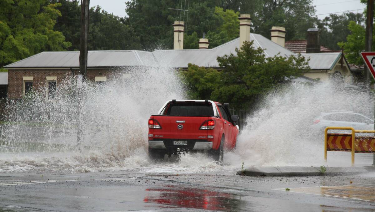 SPRAY TOWN Reader John Kich caught this shot of a car plowing through the very large puddles on Saturday morning. Photo: JOHN KICH