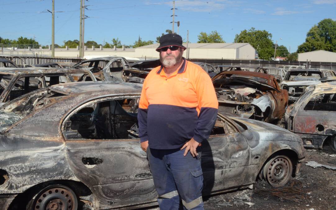 CINDER: JG Auto Sales owner John Grum stands in his car yard which was destroyed by fire. Photo: DAVID FITZSIMONS