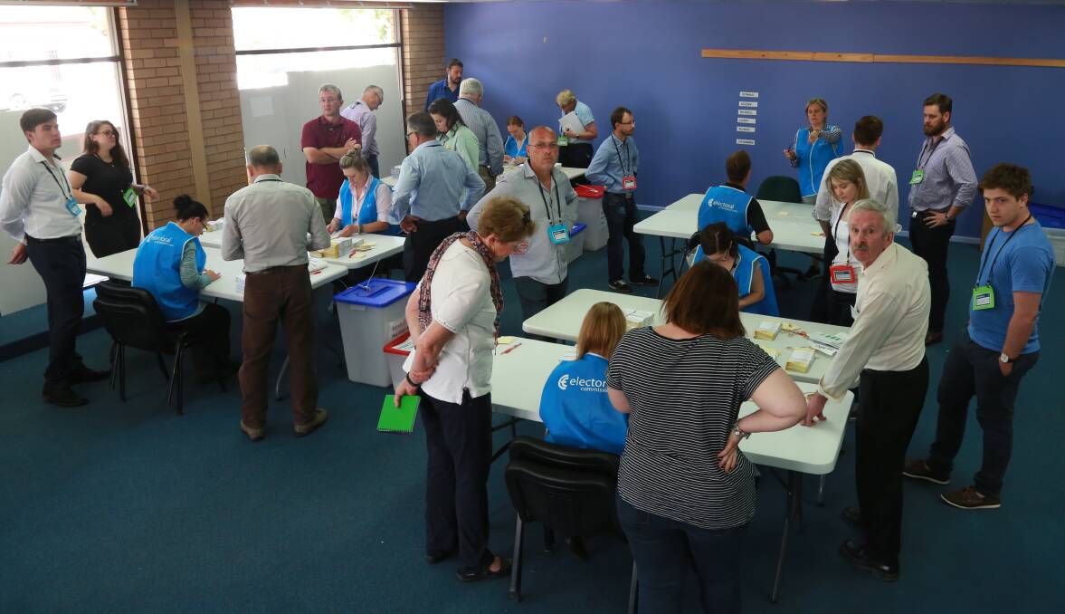 BACK AT WORK: NSW Electoral Commission staff and scrutineers on Monday morning. Photo: PHIL BLATCH