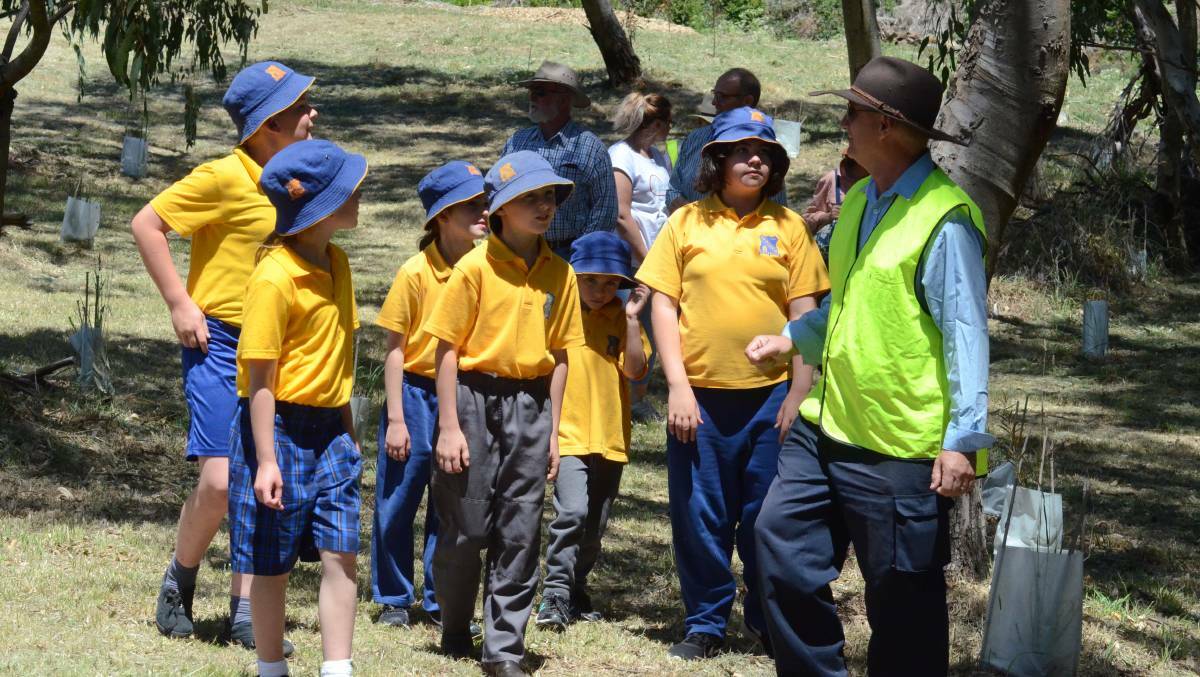 TAKING IT IN: Supervisor of Parks and Recreation at Blayney Shire Council Brian Parker with students from Carcoar Public School checking out the revived area.