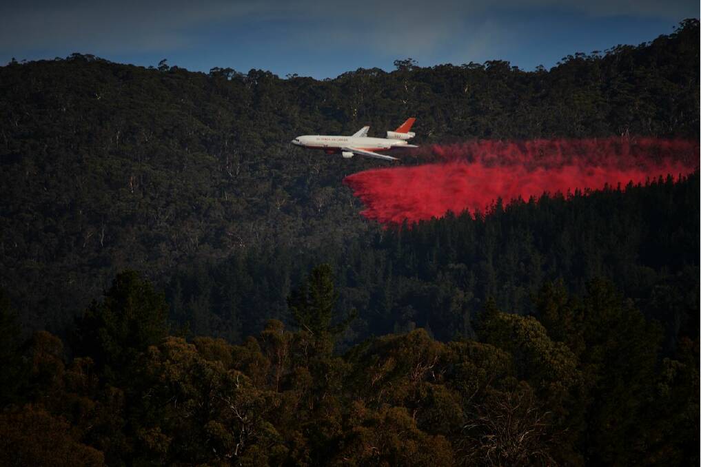 WORKING HARD: The DC-10 Air Tanker drops another load of fire retardant on the Mount Canobolas blaze. Photo: SCOTT GILBANK