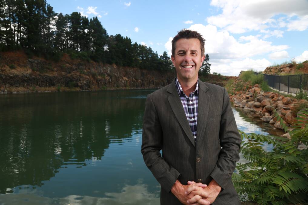 NEW DEVELOPMENT: One Agency real estate agent Ash Brown in front of the quarry at Bluestone Lake. Photo: PHIL BLATCH