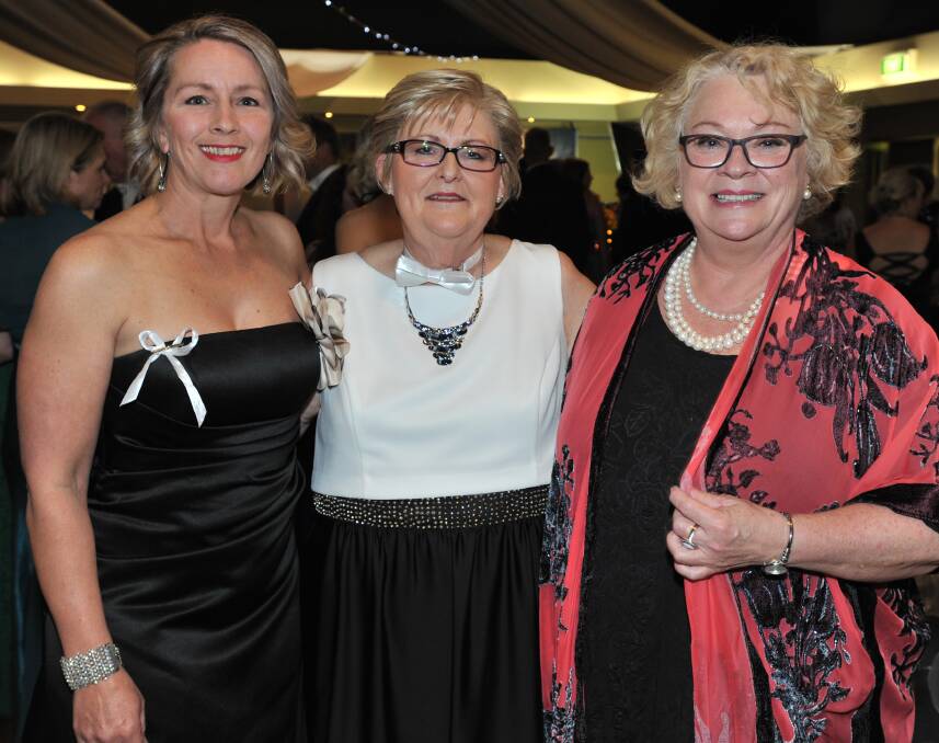 DRESSED UP: Kathryn Humphrys, Julianne Potts and Ailsa Graham at the 2017 White Tie Ball. Photo: JUDE KEOGH. 