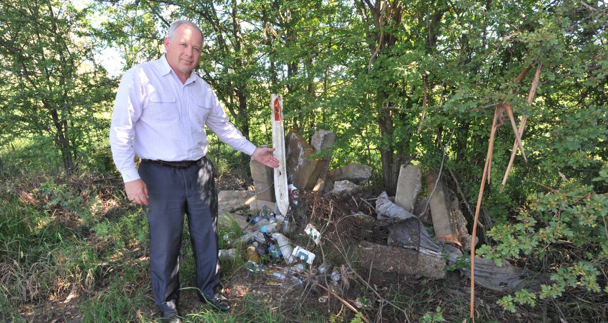 WASTE SCOURGE: Councillor Jeff Whitton at Bargwanna Road, one of Orange's illegal dumping hotspots. Photo: JUDE KEOGH 1209jkdump1