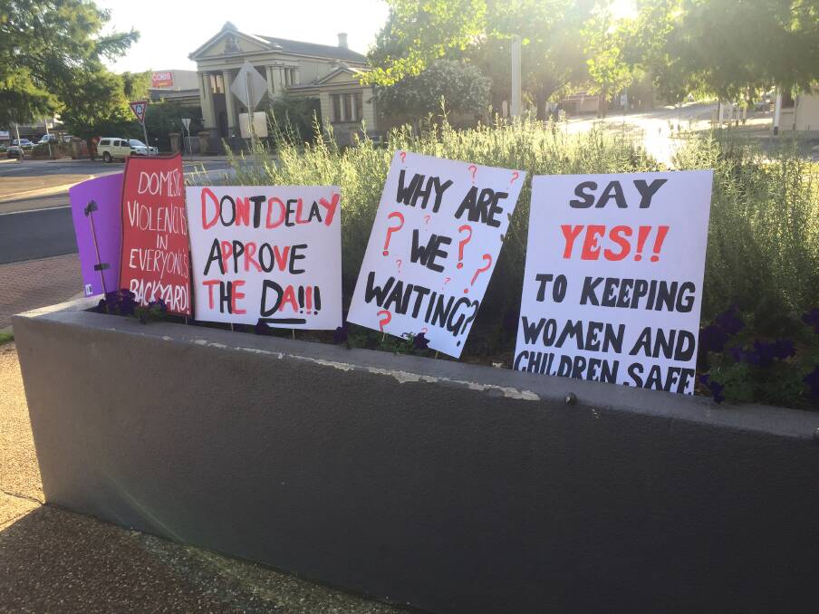 Placards out the front of Orange City Council on Tuesday night, before the vote.
