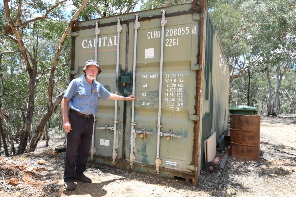 DISAPPOINTED: Ophir Reserve Trust secretary Denis Marsh with the shipping container damaged in Monday morning's stealing. Photo: JUDE KEOGH 0110jkophir1