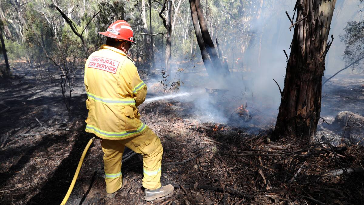 THICK OF IT: Coonamble Rural Fire Brigade's Marty Harrison quenches flames along Mount Canobolas Road. Photo: ANDREW MURRAY 0213amfire8