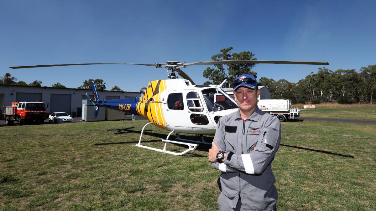 HELP FROM ABOVE: Pilot Ben Surawski has been helping out with the Mount Canobolas water-bombing effort. Photo: ANDREW MURRAY 0214amheli1