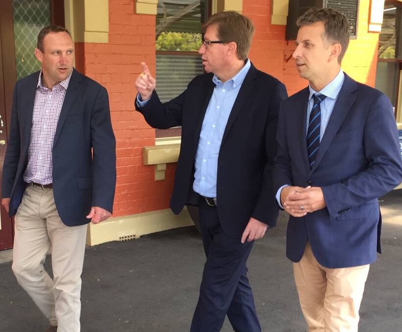TALK THE TALK: Nationals byelection candidate Scott Barrett with Deputy Premier Troy Grant and Transport Minister Andrew Constance at the Orange railway station on Friday. Photo: DAVID FITZSIMONS