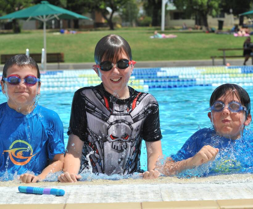 BEAT THE HEAT: Ryley, Zeke and Elye Miller joined the crowds at the Orange Aquatic Centre to cool off as the temperature rises this week. Photo: JUDE KEOGH 0111jkpool9