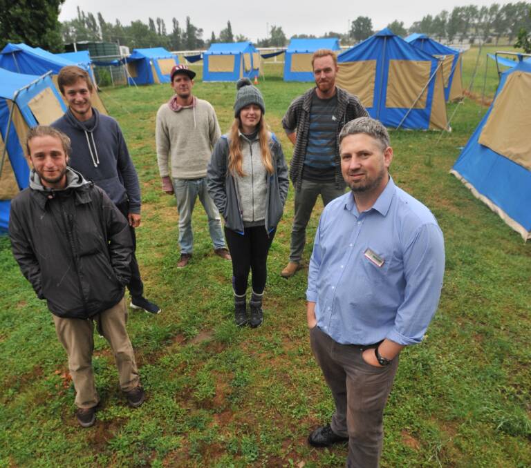 SUCCESS: Backpacker fruit pickers with campsite manager Brendon Argyle when the site started. Photo: JUDE KEOGH