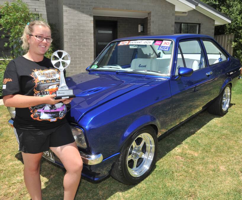 BLUE RIBBON: Sharon Rosser shows off the trophy she won at this year's Summernats for the work on her cool 1978 Ford Escort. Photo: JUDE KEOGH