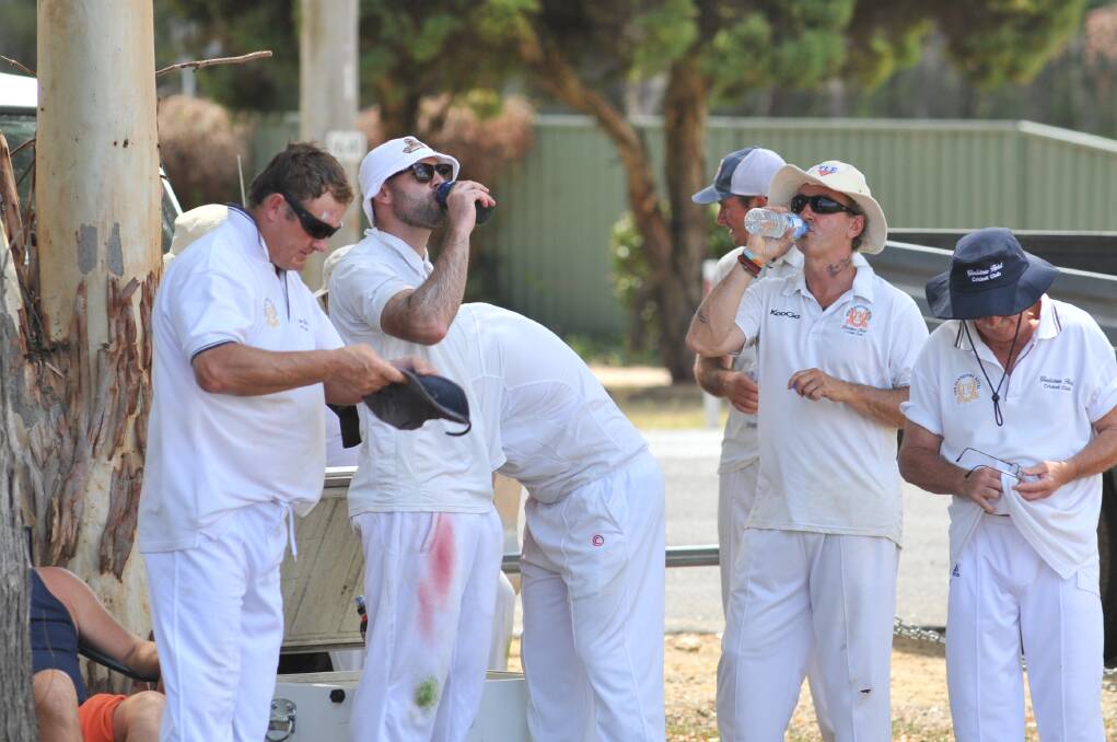 HOT STUFF: Gladstone players combat the intense heat with cold drinks at Sir Jack Brabham Park on Saturday afternoon. Photo: JUDE KEOGH