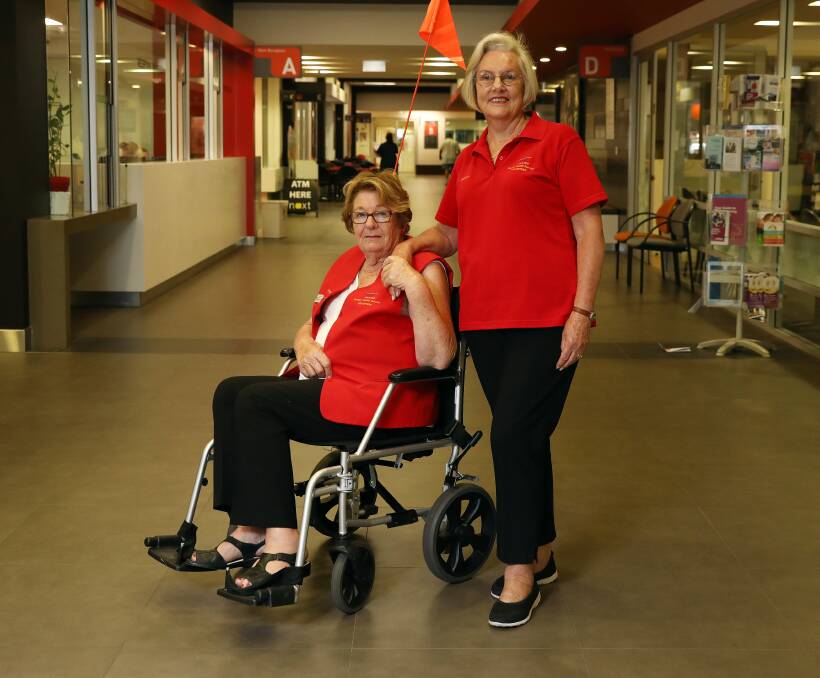 IN DEMAND: Orange hospital Wayfinders Fay Coulston and Neryl McCarthy with one of the two remaining wheelchairs. Photo: ANDREW MURRAY 0105amhosp3