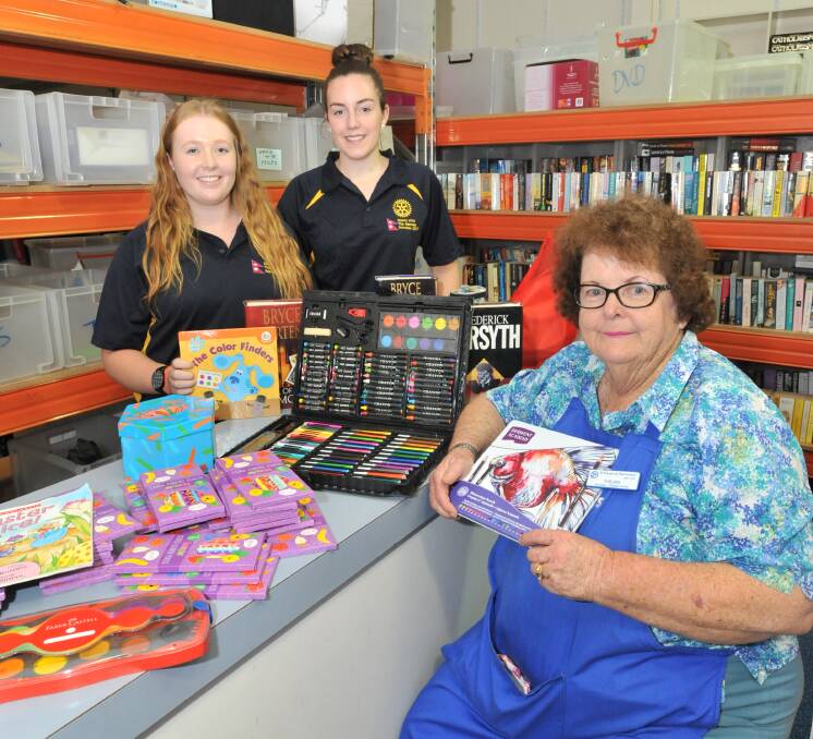 COLOURFUL CITY: Eliza Gilbank-Heim with Caitlyn Harvey and Vinnies volunteer Thelma Garey who has been collecting pencils for the students to take to Nepal for local schools. Photo: JUDE KEOGH 0316jknepal3