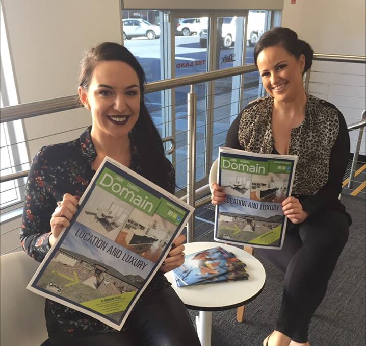 ALL SMILES: Sales manager Skye Freshwater and sales representative Melissa Foley with the latest expanded version of the Domain guide.