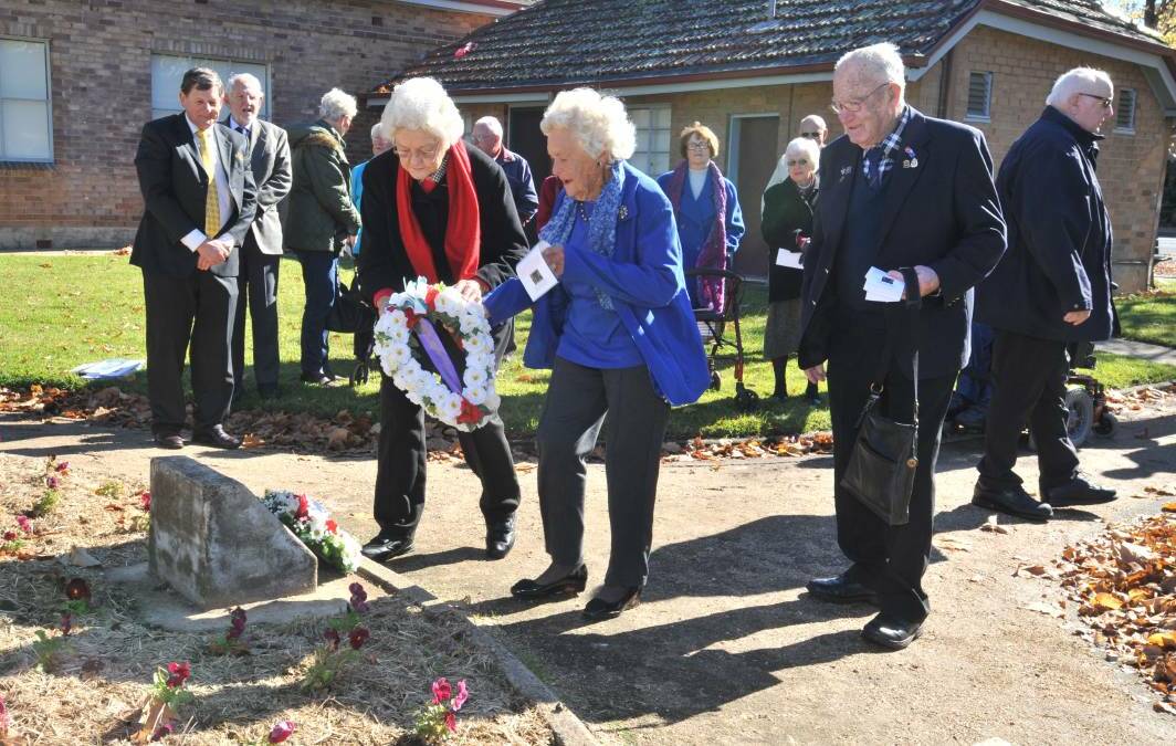 LIFE OF SERVICE: Norma Corse and Nita Bowers, granddaughters of George Patrick Rauchle, who is believed to have survived four wars, lay a wreath at the Boer War memorial service in 2016. Photo: JUDE KEOGH