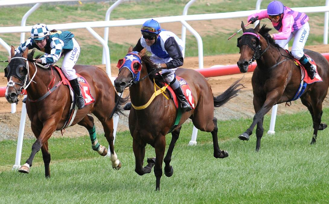 ROMPING HOME: Ricky Blewitt rides Bemiles (2) to victory in the Orange Trophy Handicap at the Orange Picnic races last year. Photo: JUDE KEOGH