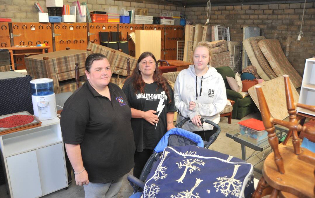 SAD DAY: Pay It Forward volunteer staff Teresa Hargraves, Leonie Turner and Trinity Irwin in the soon to be closed free furniture warehouse. Photo: JUDE KEOGH 1107jkpayit1