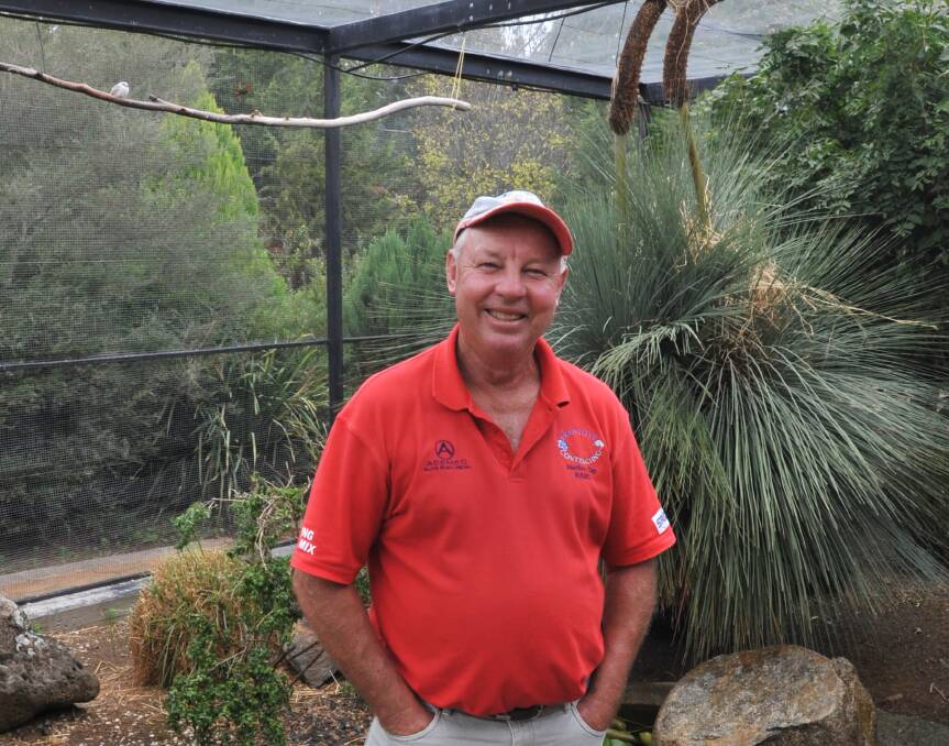 WINGED WONDERLAND: Orange Bird Society president Tony Ford with his collection of small birds in his backyard aviary. Photo: JUDE KEOGH