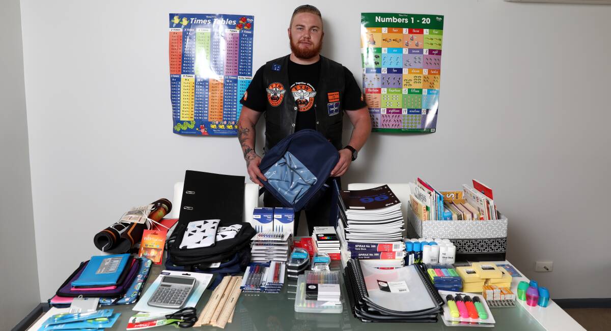 VITAL WORK: Jarrod Murphy with some of the items already donated to help out school children this year. Photo: ANDREW MURRAY 0102amcharity1