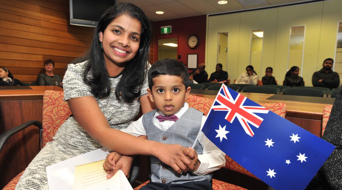 WAVING THE FLAG: Indian-born Catherine Neethu George, with son Daniel Diju, who became Australian citizens in Orange this week. Photo: JUDE KEOGH 0628jkcitizen1 