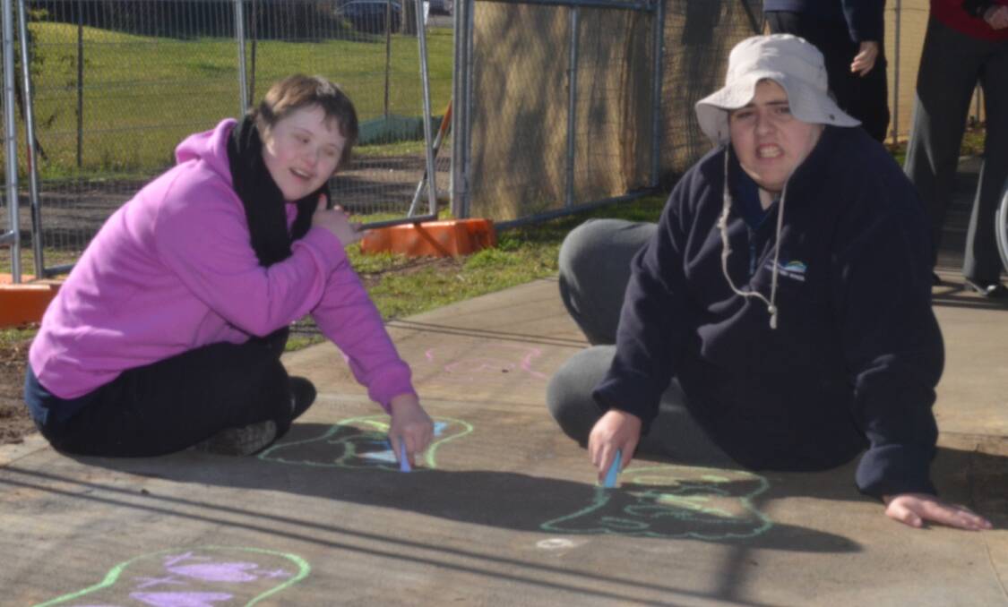 FOOTPRINTS: Libby Dante and Nicholas Di Mauro of year 10 were enjoying the chalk drawing activity on a sunny Monday morning at Anson Street School.