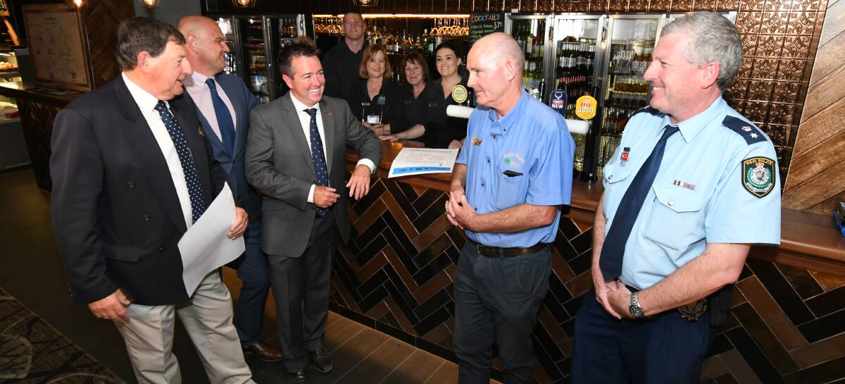 CAMPAIGN: Mayor Reg Kidd, Orange Ex-Services' Club CEO Cameron Provost, Racing Minister Paul Toole, Orange Liquor Accord president Bill Kelly and Chief Inspector Peter Atkins with bar staff Cathy Dowling, Ben Codey, Kristine Lawler, Nevelle Butler and Leisa Green. Photo: JUDE KEOGH 0122jkangela6