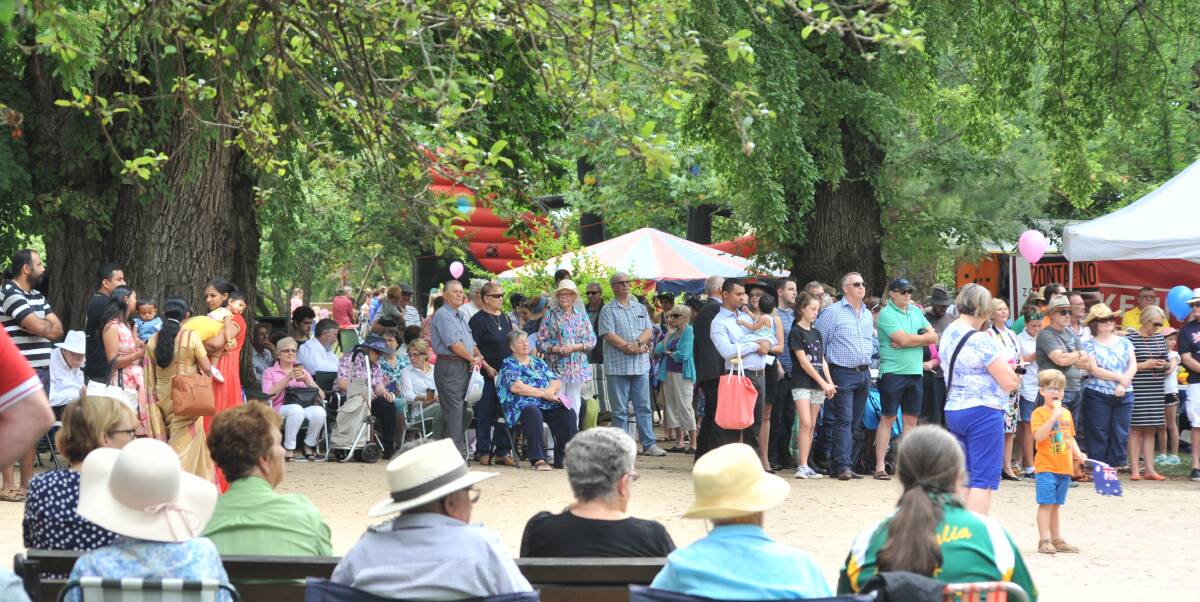 SHIFTING: Crowds gather under the trees in Cook Park for last year's Australia Day celebrations. Photo: JUDE KEOGH 0126jkaust42