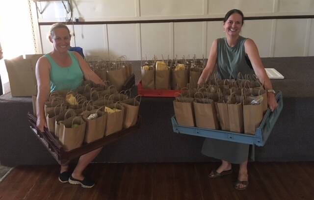 HELPING OUT: Volunteers Rachel Balcomb and Leanne Wynn assisted preparing lunches for firefighters from donations at Nashdale Hall on Monday. Photo: Supplied