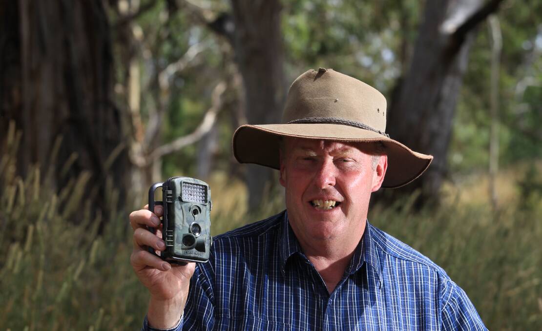 FIGHT BACK: NSW Farmers Orange branch chair Bruce Reynolds with a motion-sensing camera local landholders are buying to identify trespassers. Photo: PHIL BLATCH 
