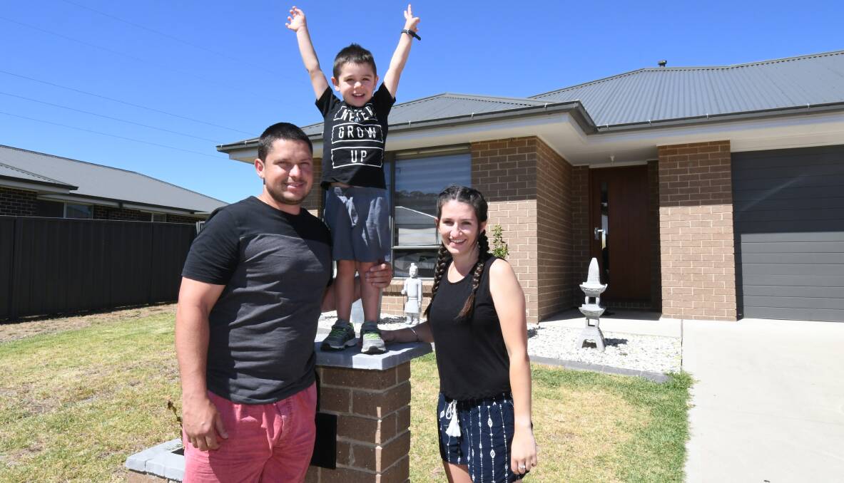 WE'RE EXCITED: Wayne Collett, Tayson Collett and Emma Georgiou celebrate buying  in Orange with the help of first home buyer benefits. Photo: JUDE KEOGH 0119jkhome4