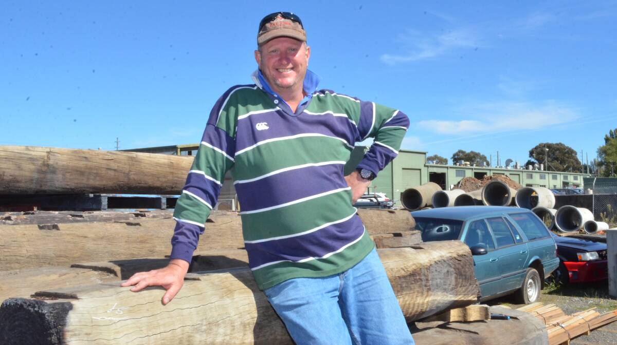 READY TO RECYCLE: Furniture maker Rod Devries was all smiles after buying 40 salvaged hardwood logs at the council auction. Photo: DAVID FITZSIMONS