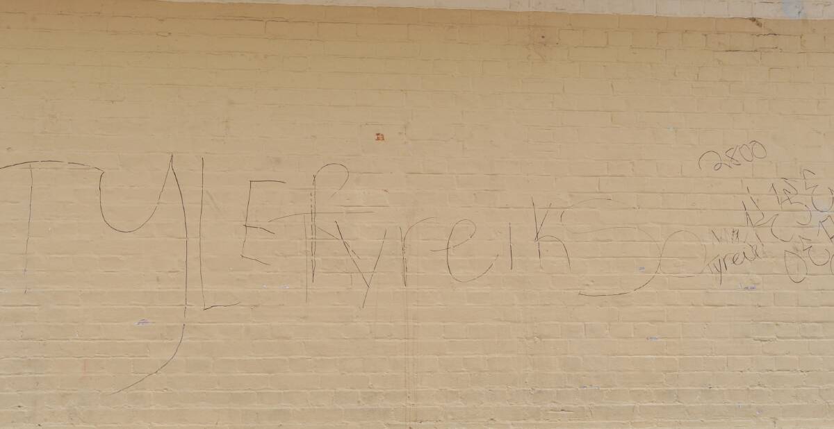 VANDALISM: Tags graffitied on a wall in Post Office Lane last week.