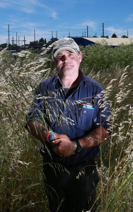 GRASSED OFF: Orange resident Tony Briggs fears the long grass around McLachlan and Spring streets will lead to a fire. Photo: PHIL BLATCH