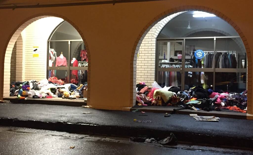 DUMPED: Piles of old clothing lay scattered at the front of St Vincent de Paul's Orange headquarters in McNamara Street on Sunday night. Photo: Contributed