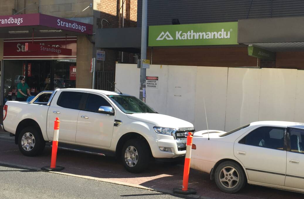 CLOSED DOORS: Hoardings and asbestos removal signs surround the Kathmandu clothing store on Summer Street. Photo: DAVID FITZSIMONS