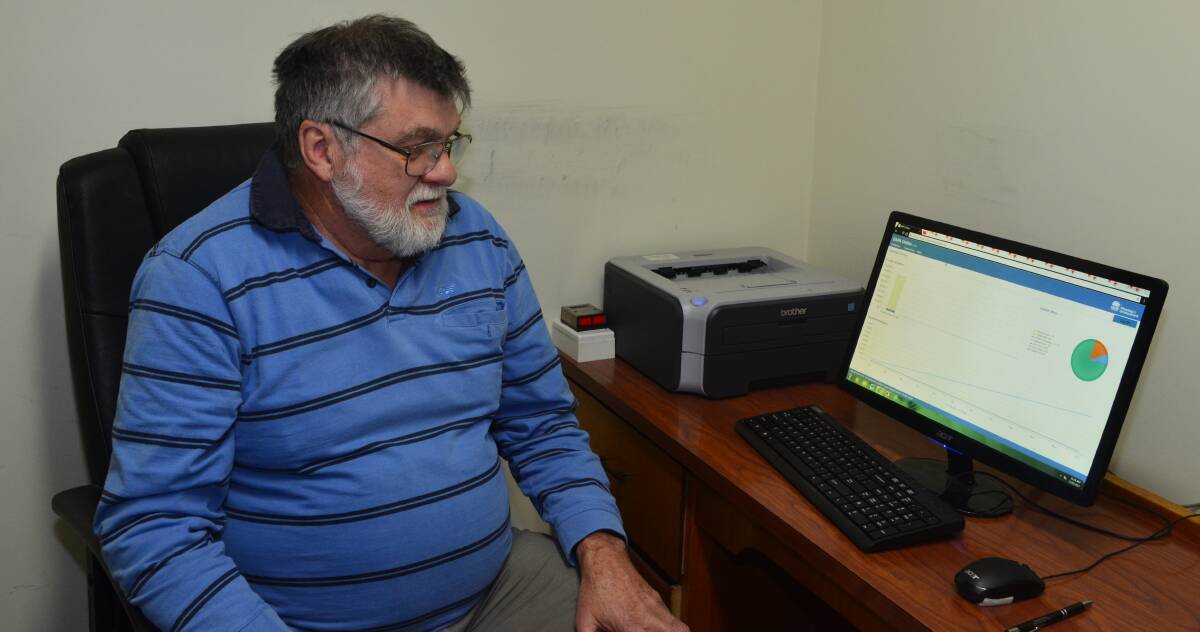 POINTY END: St Vincent de Paul Society Orange Regional president Michael Horth handles requests for the new online power bill vouchers in Orange. Photo: DAVID FITZSIMONS