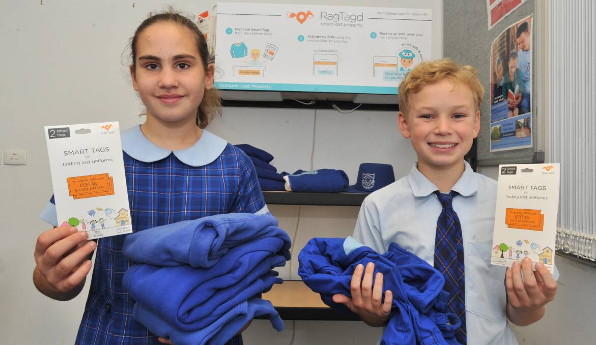 LOST AND FOUND: Jasmine Anthony and Keenan Zegzula show off Bletchington Public School's new lost property 'smart tags.' Photo: JUDE KEOGH 0316jktag1 