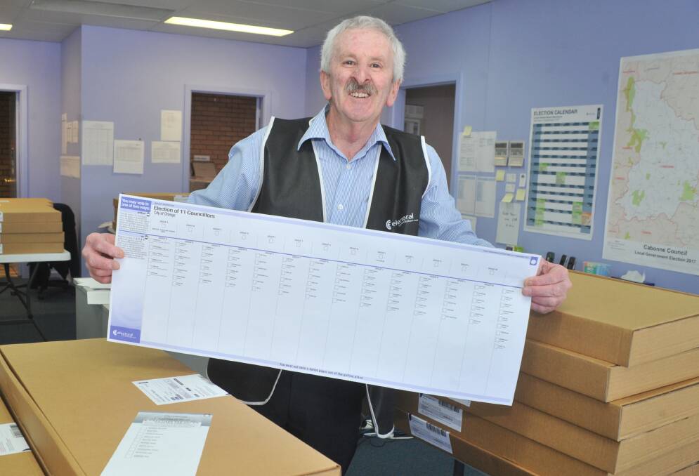 HERE IT IS: Returning officer Ross Baker unveils the table runner size ballot paper Orange voters will have to fill in for the council election. Photo: JUDE KEOGH 0823jkballot1