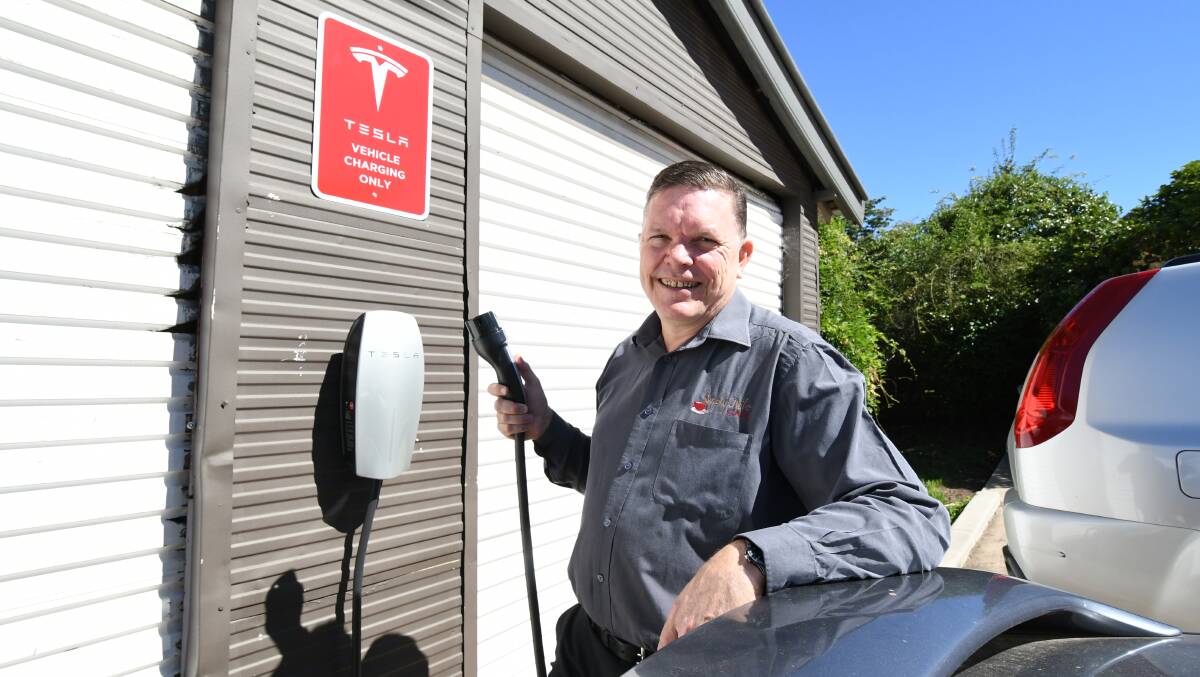 PLUG AND GO: Simply Nile Cafe owner Frank Mohun with the Tesla electric car charger installed at his Nile Street premises. Photo: JUDE KEOGH 0116jkteslr2